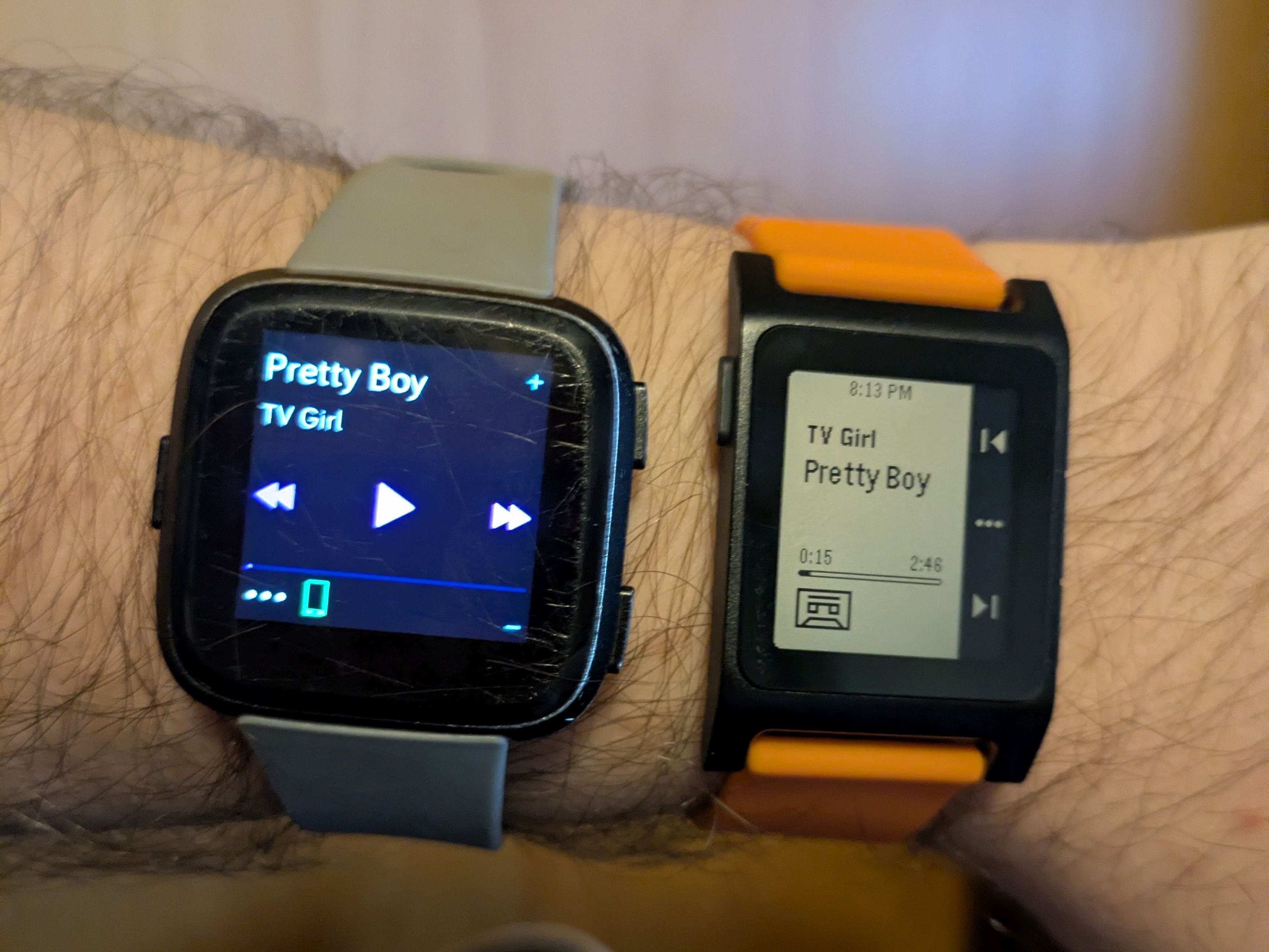A photo showing a side by side of the Fitbit Versa and the Pebble Core 2 Duo